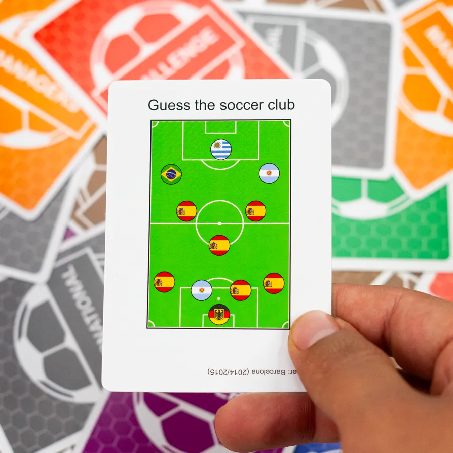 An Ultimate Soccer Trivia question card held in front of the game box